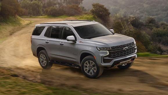 A silver 2023 Chevy Tahoe traveling off road