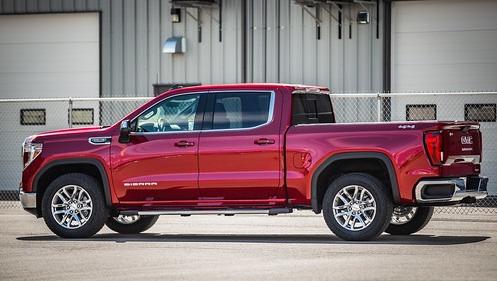 Red 2022 GMC Sierra 1500 parked in front of an industrial building