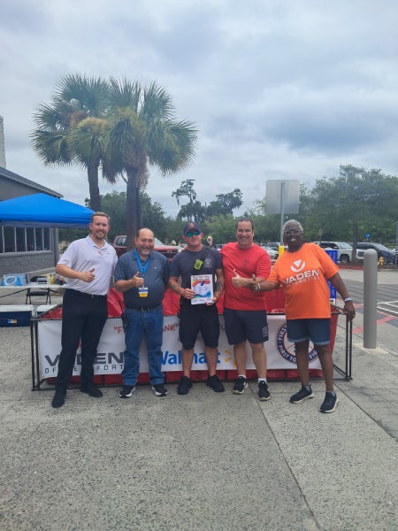 Vaden team and staff with supply bags