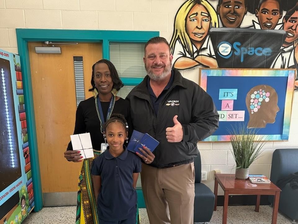 A person standing with a teacher and a student