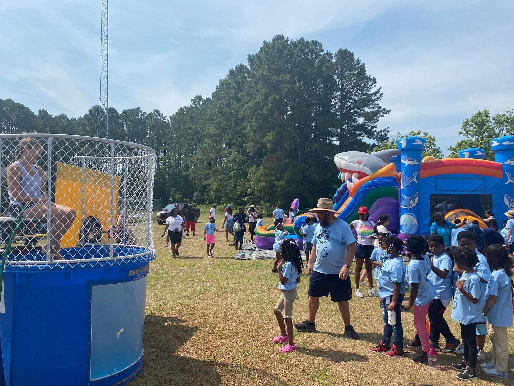 A group of kids throwing balls at a dunk tank